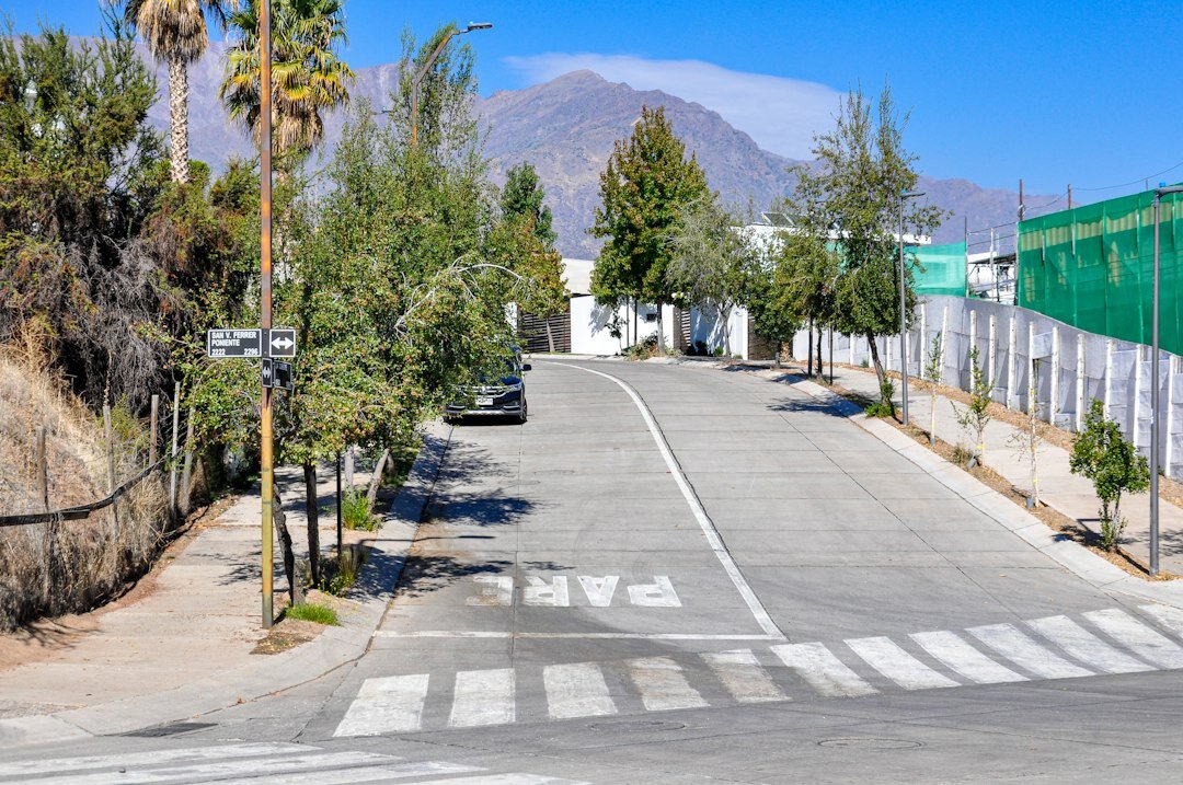 Wide street scene in Santiago with pedestrians and the Andes mountains in the background