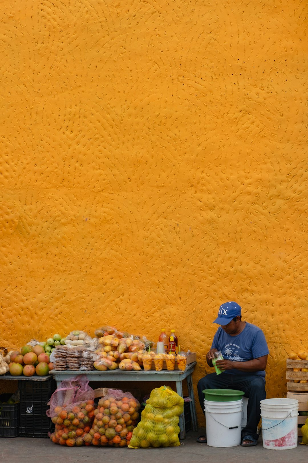 Portrait of a Chilean street vendor selling fruit at an outdoor market stall
