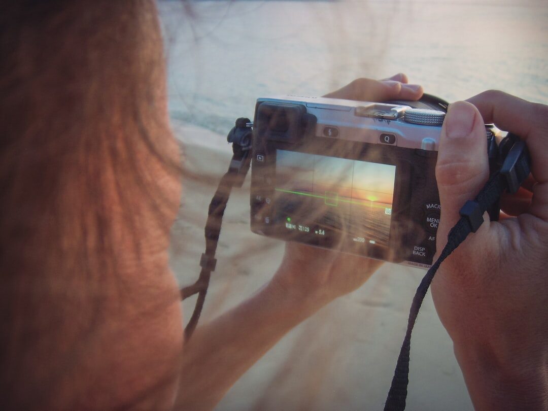 A Chilean documentary photographer reviewing photographs on a camera screen