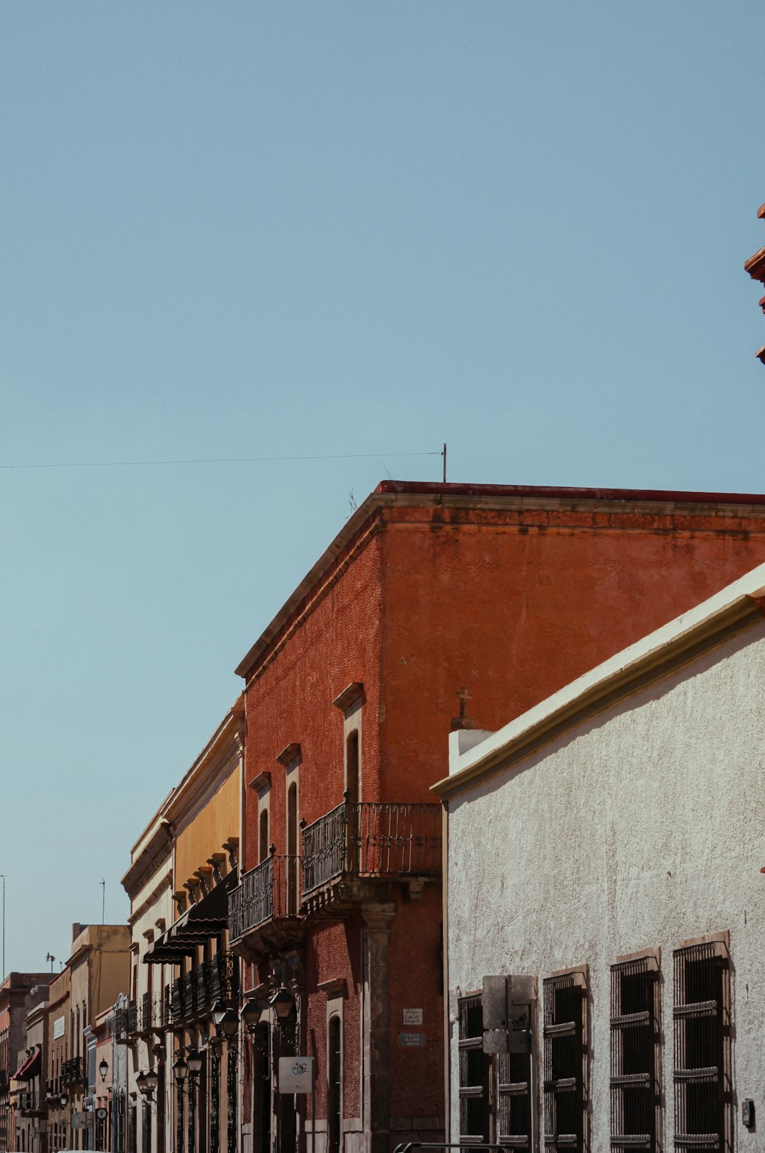 Colorful old building facades on a narrow street in a Santiago neighborhood