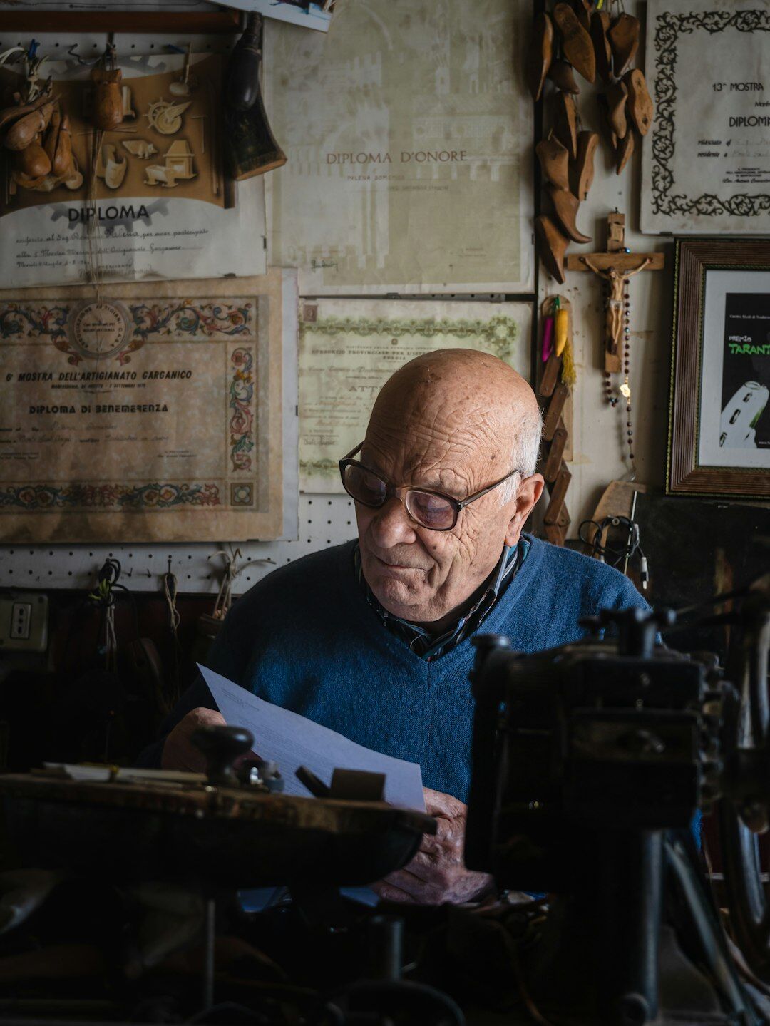 Portrait of an elderly Chilean shoemaker working in his small workshop